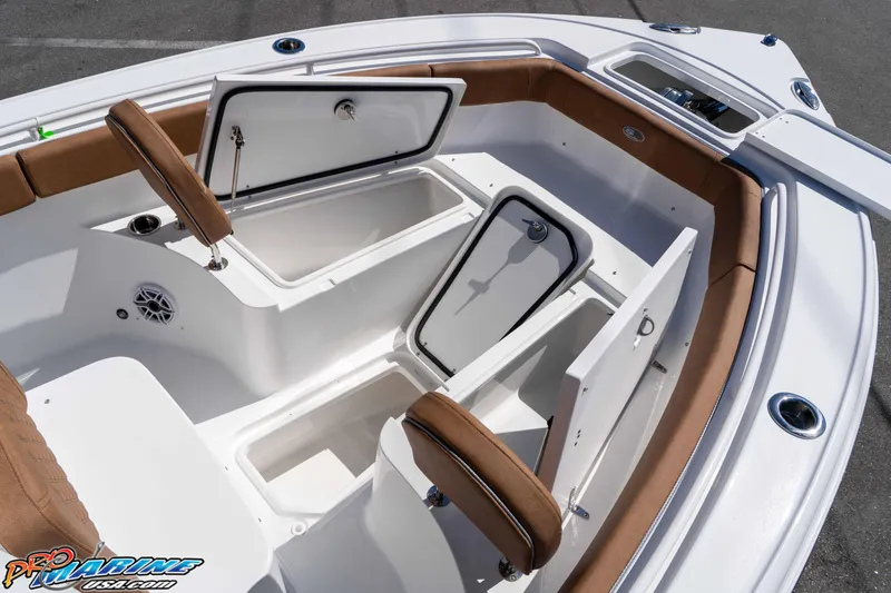 Slide: The Image of 2026 Sea Hunt Ultra 255 SE boat interior with open storage compartments and cushioned seating. - 40