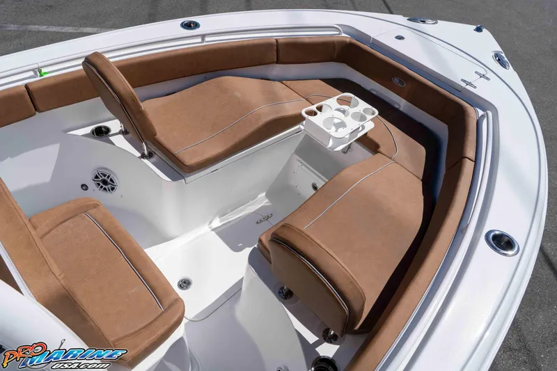 Slide: The Image of 2026 Sea Hunt Ultra 255 SE boat interior with brown cushioned seating and cup holders. - 41