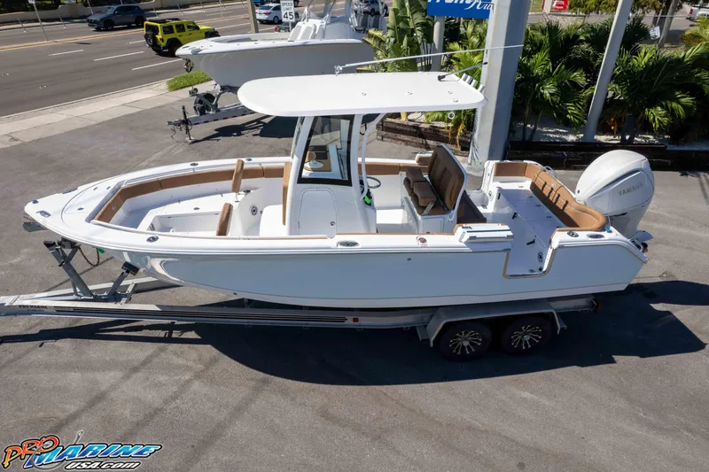 Slide: The Image of 2026 Sea Hunt Ultra 255 SE boat on trailer, parked outdoors. - 6