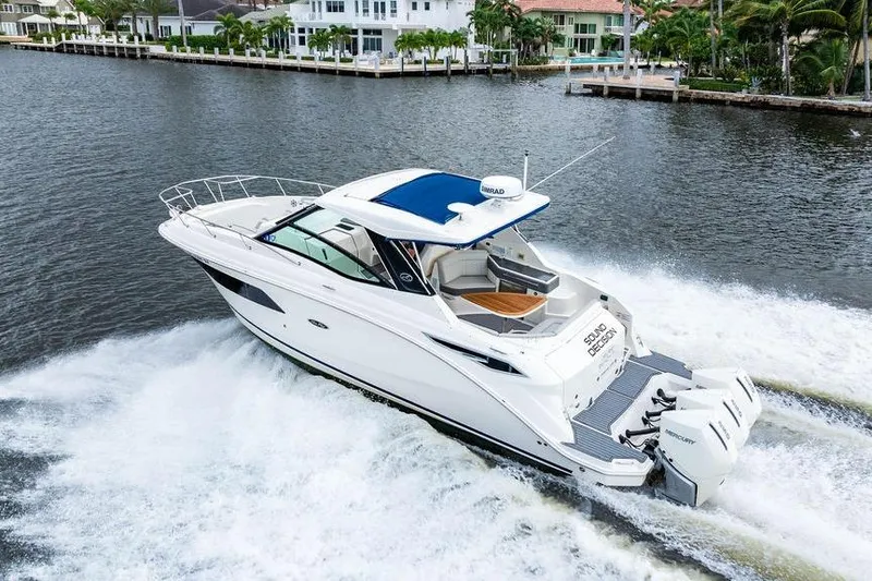 Slide: The Image of 2021 Sea Ray Sundancer 320 Outboard cruising on a scenic waterway. - 11