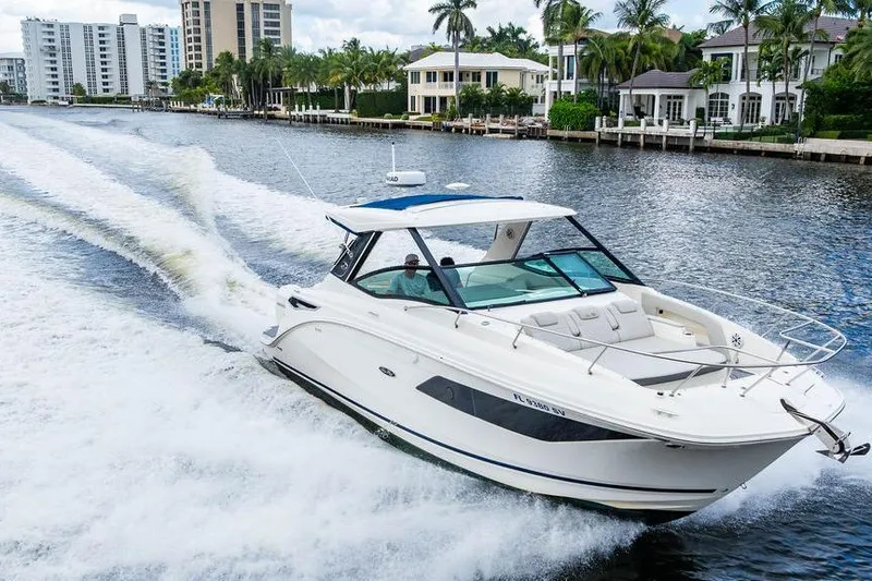 Slide: The Image of 2021 Sea Ray Sundancer 320 Outboard cruising on a scenic waterway. - 16