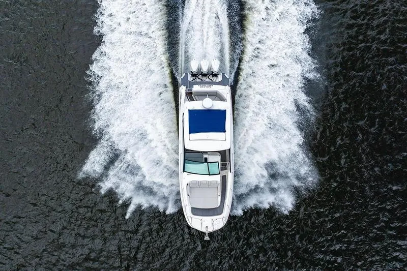 Slide: The Image of Aerial view of 2021 Sea Ray Sundancer 320 Outboard cruising on water. - 18