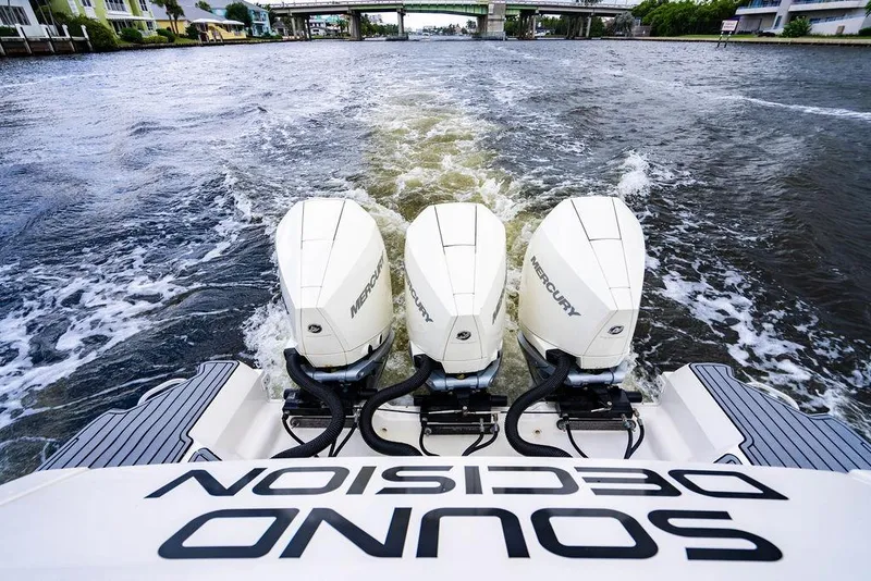 Slide: The Image of 2021 Sea Ray Sundancer 320 Outboard with triple Mercury engines on water. - 22