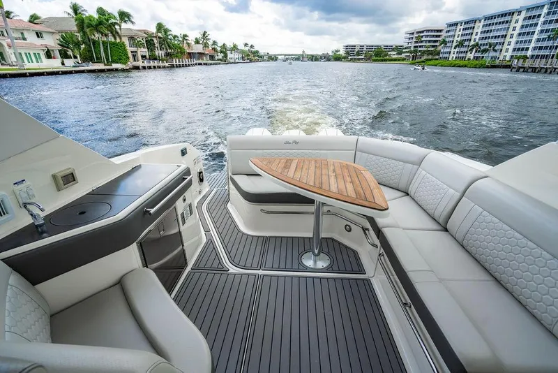 Slide: The Image of 2021 Sea Ray Sundancer 320 Outboard interior with elegant seating and scenic waterway view. - 26