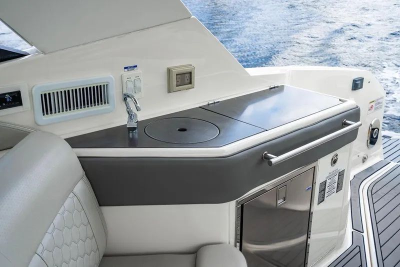 Slide: The Image of 2021 Sea Ray Sundancer 320 Outboard boat interior with kitchenette and water view. - 27