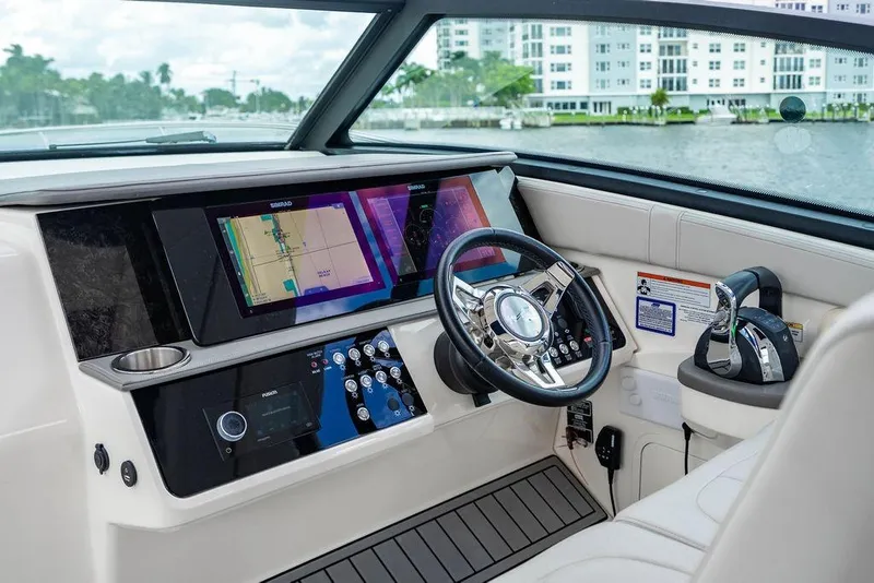 Slide: The Image of 2021 Sea Ray Sundancer 320 Outboard helm with modern navigation displays and controls. - 38
