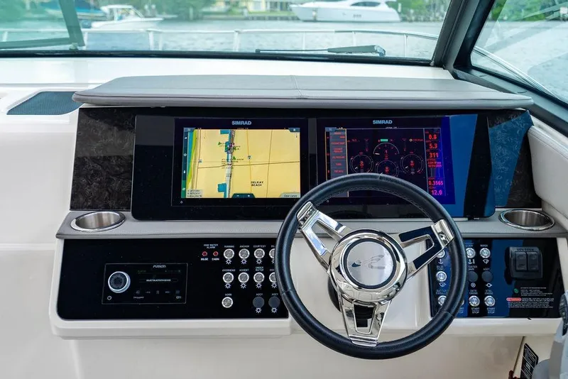 Slide: The Image of 2021 Sea Ray Sundancer 320 Outboard dashboard with navigation screens and controls. - 39