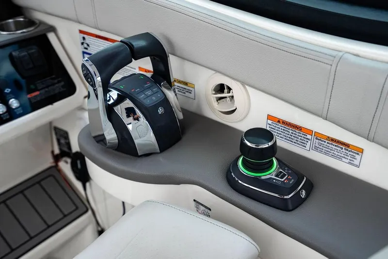 Slide: The Image of 2021 Sea Ray Sundancer 320 Outboard helm controls with joystick and throttle. - 40