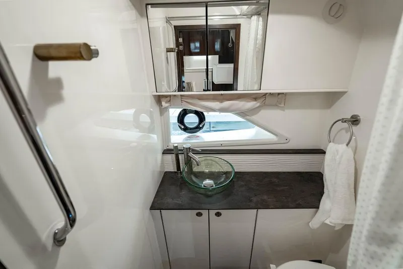 Slide: The Image of 2021 Sea Ray Sundancer 320 Outboard bathroom with modern sink and mirror. - 59