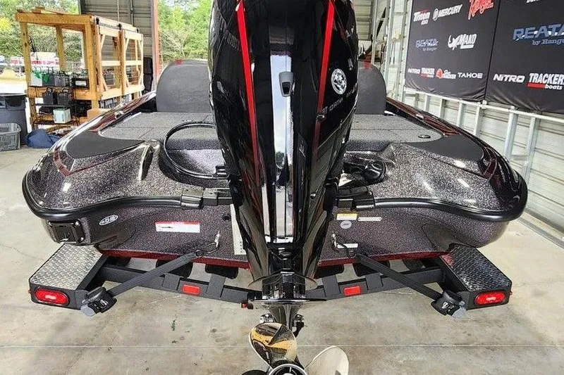 Slide: The Image of 2026 Triton 179 TrX boat on trailer, rear view in a garage setting. - 4