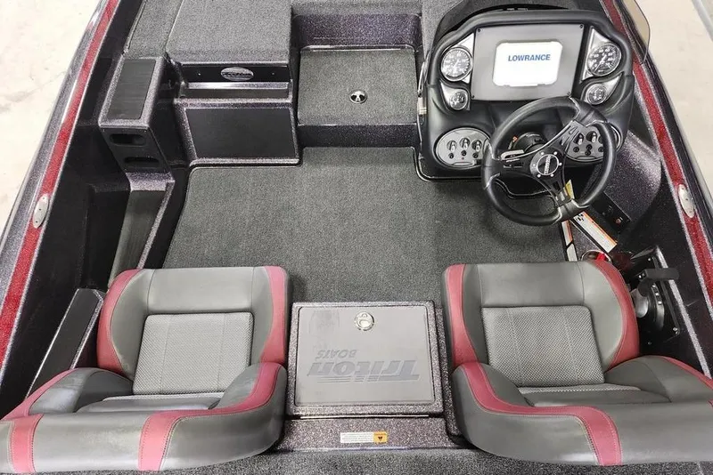 Slide: The Image of 2026 Triton 179 TrX boat interior with dual seats and steering console. - 5