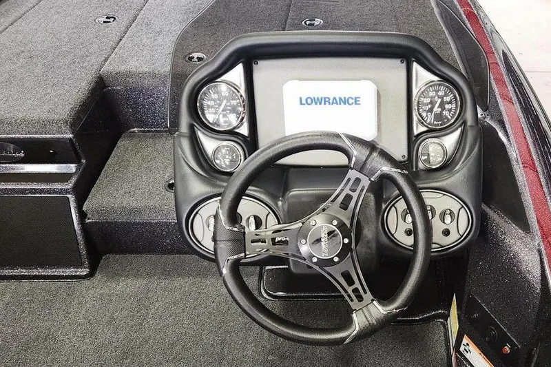 Slide: The Image of 2026 Triton 179 TrX boat dashboard with Lowrance display and steering wheel. - 6