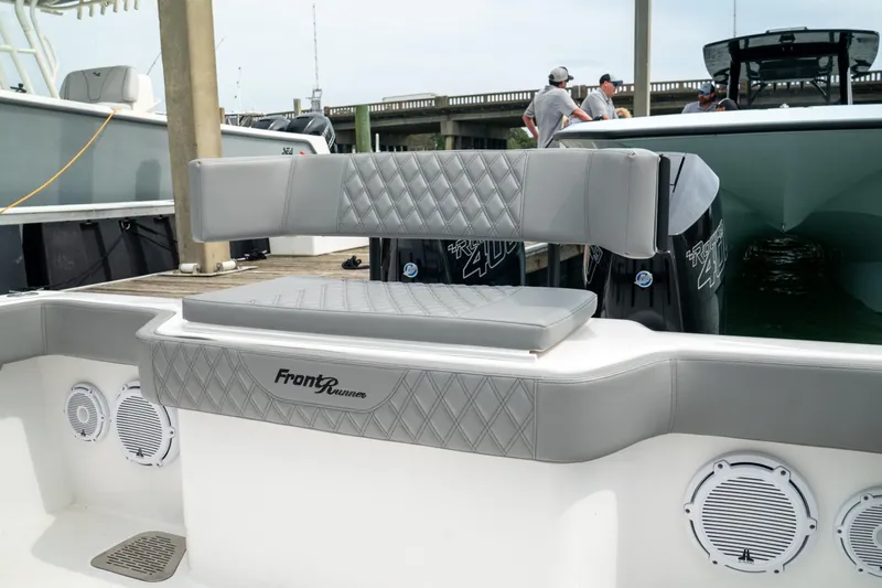 Slide: The Image of 2026 Front Runner 33' Center Console boat with gray seating and powerful engines. - 10