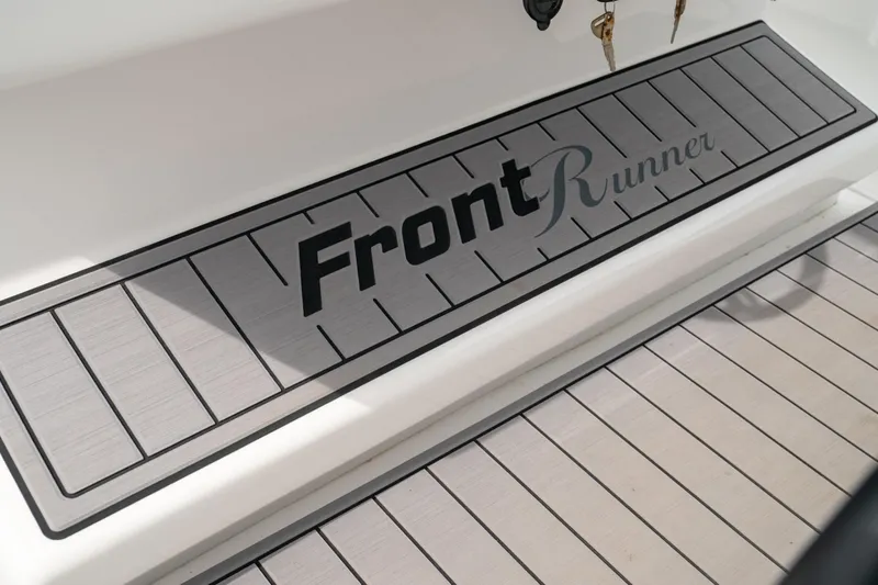 Slide: The Image of 2026 Front Runner 33' Center Console boat deck with logo, featuring sleek design. - 17