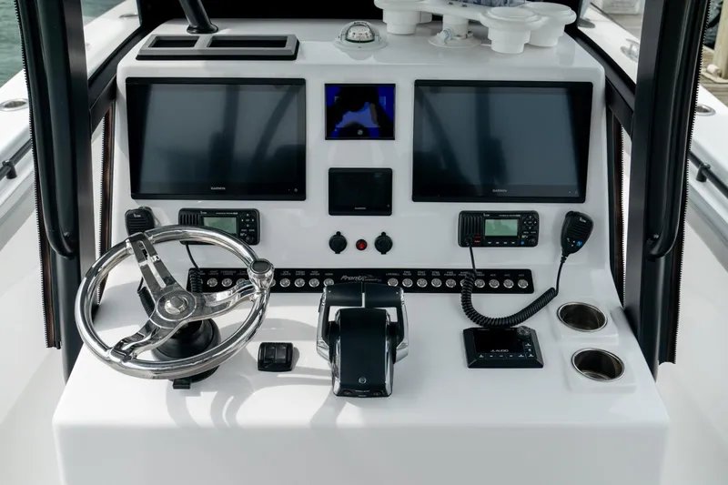 Slide: The Image of 2026 Front Runner 33' Center Console boat dashboard with dual screens and controls. - 19