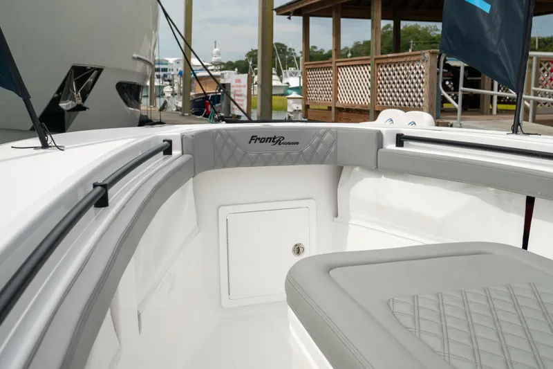 Slide: The Image of 2026 Front Runner 33' Center Console boat interior with cushioned seating and storage. - 5