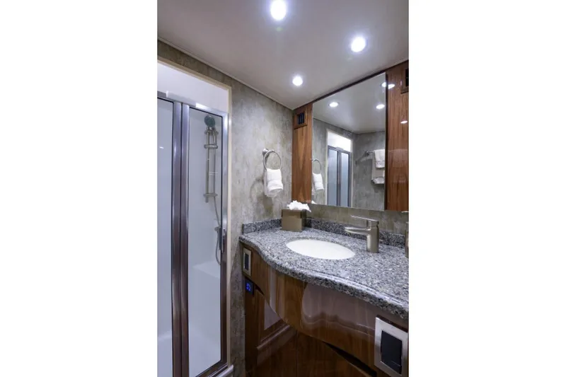 Slide: The Image of Luxurious bathroom in 2017 Viking 48 Convertible yacht with granite countertop and modern fixtures. - 11
