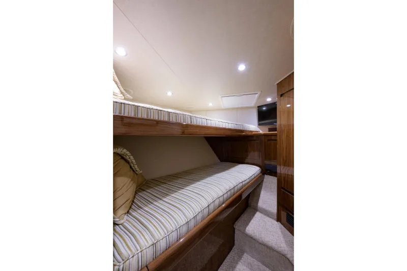 Slide: The Image of Interior of 2017 Viking 48 Convertible yacht with cozy bunk beds and wooden finish. - 12