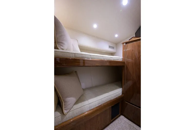 Slide: The Image of Interior of 2017 Viking 48 Convertible yacht with cozy bunk beds and wooden cabinetry. - 13