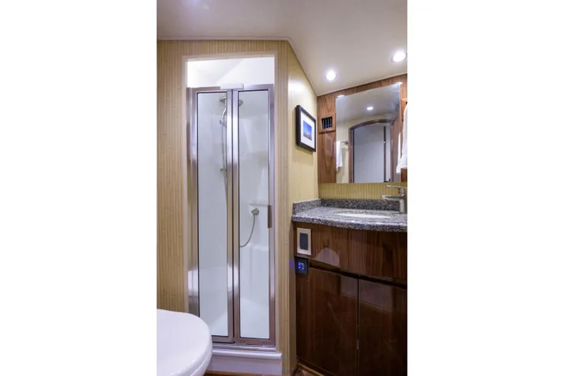 Slide: The Image of Luxurious bathroom in 2017 Viking 48 Convertible yacht with shower and wooden cabinetry. - 14