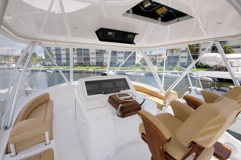 Slide: The Image of Flybridge of 2017 Viking 48 Convertible yacht with helm station and seating. - 17