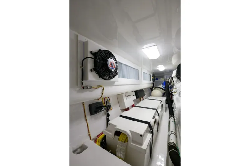 Slide: The Image of Engine room of 2017 Viking 48 Convertible yacht, featuring equipment and wiring. - 31