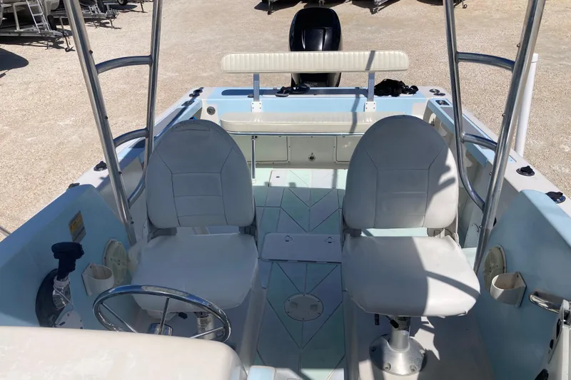 Slide: The Image of 1997 Pro-Line 255 boat interior with dual seats and steering wheel. - 16