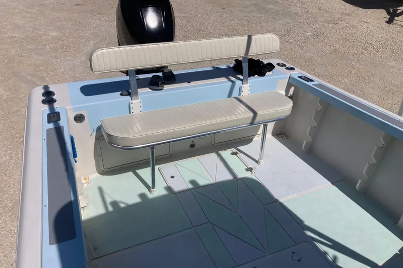 Slide: The Image of 1997 Pro-Line 255 boat interior with seating and motor, showcasing spacious deck design. - 17