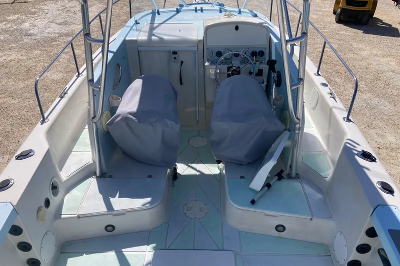 Slide: The Image of 1997 Pro-Line 255 boat interior with covered seats and steering wheel. - 5