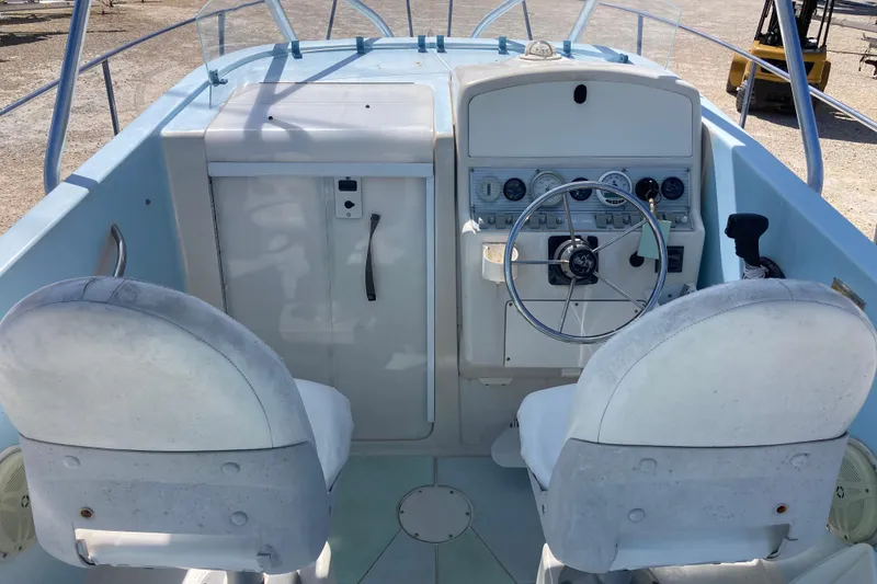 Slide: The Image of 1997 Pro-Line 255 boat cockpit with steering wheel and dual seats. - 6