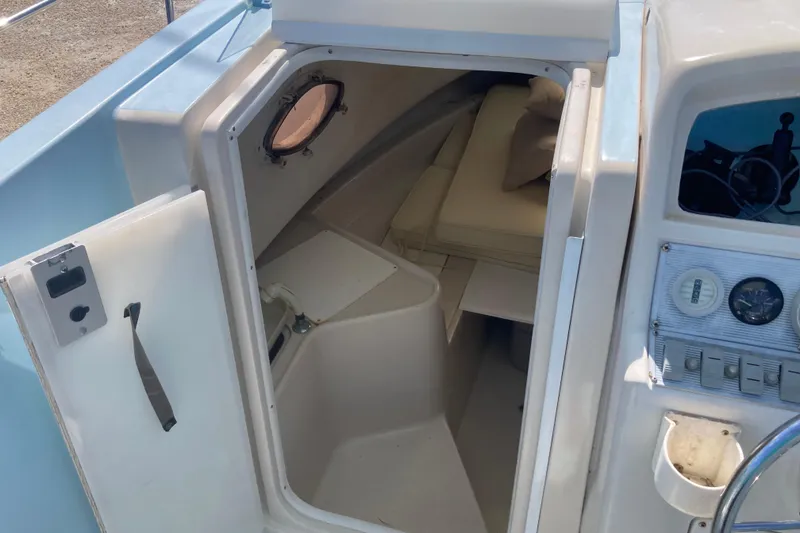 Slide: The Image of 1997 Pro-Line 255 boat cabin interior with seating and control panel. - 8