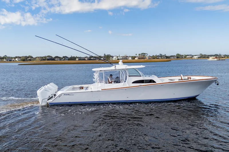 Slide: The Image of 2026 Front Runner 47' Center Console boat cruising on a calm waterway. - 6