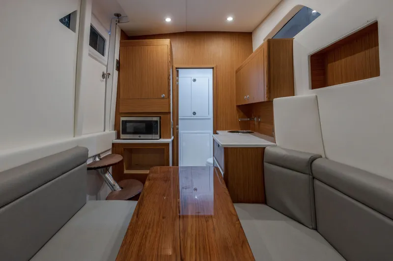 Slide: The Image of Interior of 2026 Front Runner 47' Center Console with modern kitchen and seating area. - 7