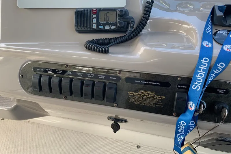 Slide: The Image of Control panel of a 2002 Cruisers 3275 Express boat with switches and radio. - 18