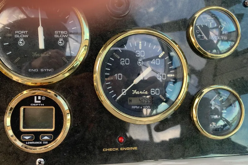 Slide: The Image of Dashboard of 2002 Cruisers 3275 Express boat with gauges and depth finder. - 19