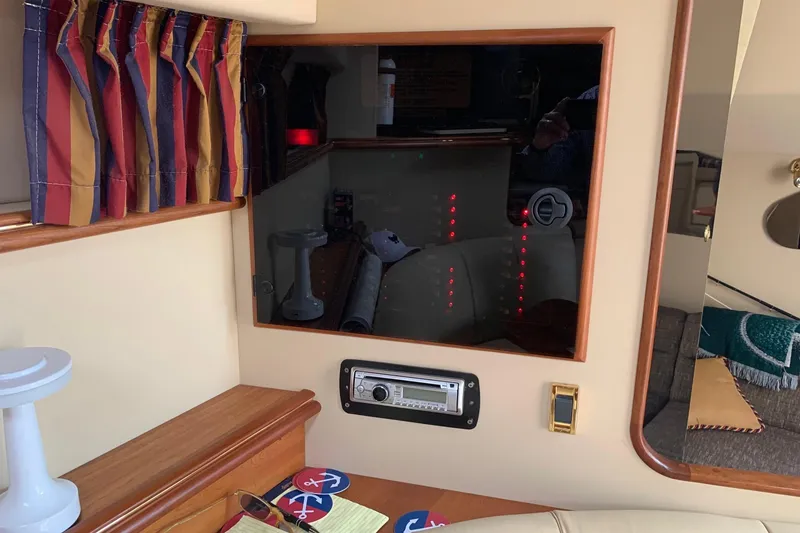Slide: The Image of Interior of a 2002 Cruisers 3275 Express boat with striped curtains and control panel. - 26