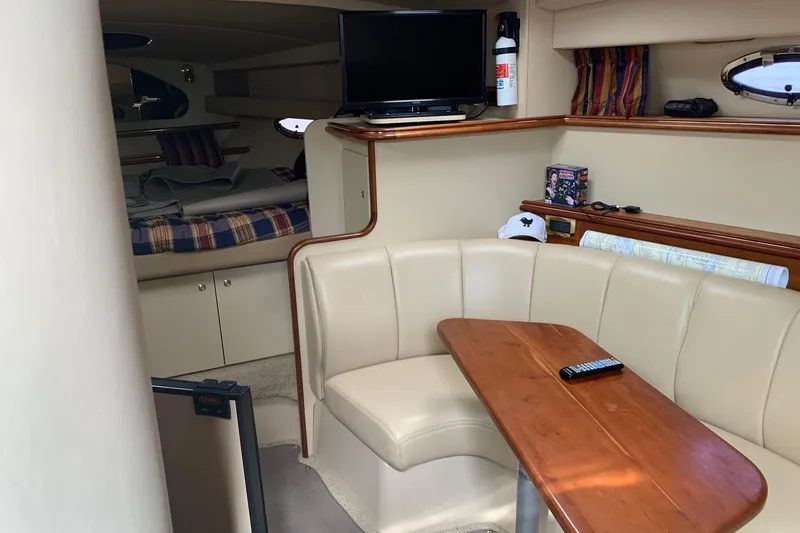 Slide: The Image of Interior of 2002 Cruisers 3275 Express yacht with seating, table, and TV. - 35
