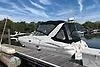 Slide: The Image of 2002 Cruisers 3275 Express boat docked under a clear blue sky. - 37