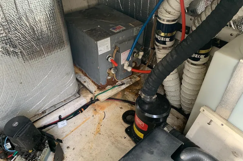 Slide: The Image of Engine room of 2002 Cruisers 3275 Express with mechanical components and wiring. - 8