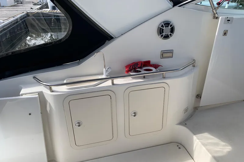 Slide: The Image of 2002 Cruisers 3275 Express yacht interior with sink, storage, and speaker. - 9