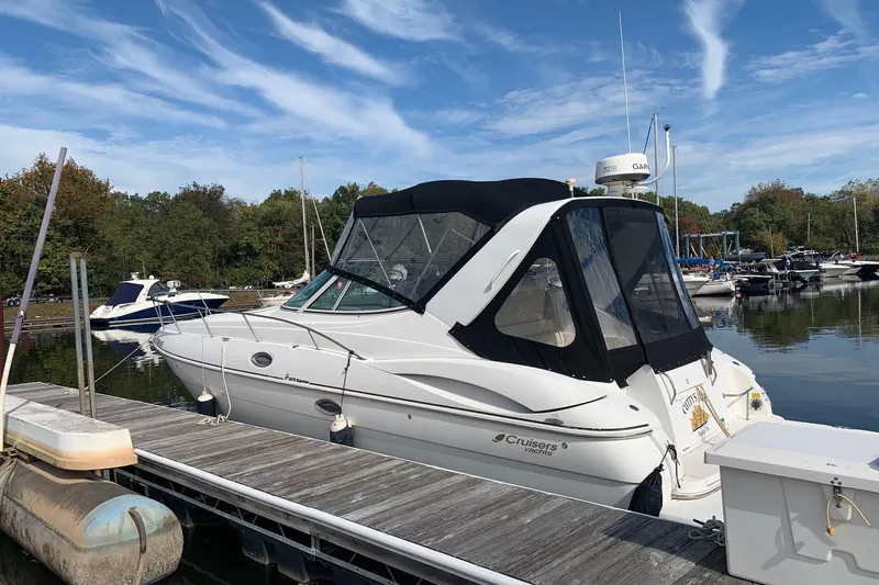 The Image of 2002 Cruisers 3275 Express yacht docked at a marina under a clear sky. - 0