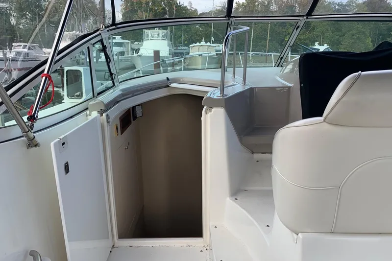 Slide: The Image of 2002 Cruisers 3275 Express boat interior with open cabin door and seating area. - 11