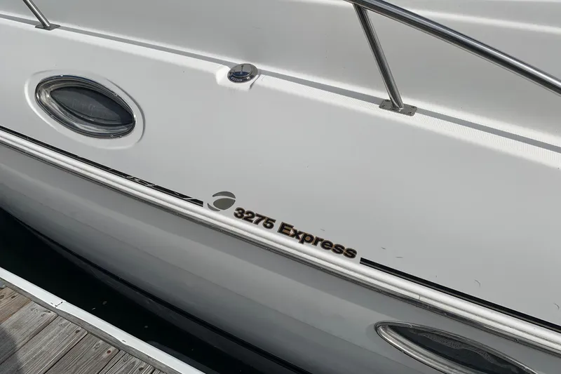 Slide: The Image of 2002 Cruisers 3275 Express boat side view with railing and window. - 15