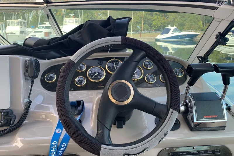 Slide: The Image of 2002 Cruisers 3275 Express boat helm with steering wheel and control panel. - 17