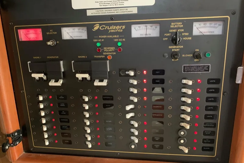 Slide: The Image of Control panel of a 2002 Cruisers 3275 Express yacht, featuring switches and indicators. - 30