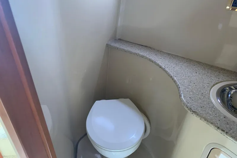 Slide: The Image of 2002 Cruisers 3275 Express bathroom with toilet and curved countertop. - 32