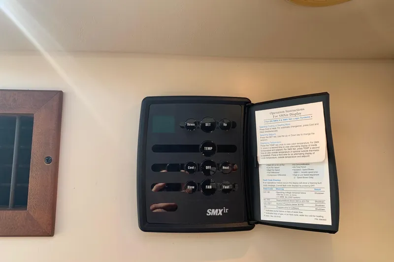 Slide: The Image of SMXir control panel with operation instructions on a 2002 Cruisers 3275 Express boat. - 4