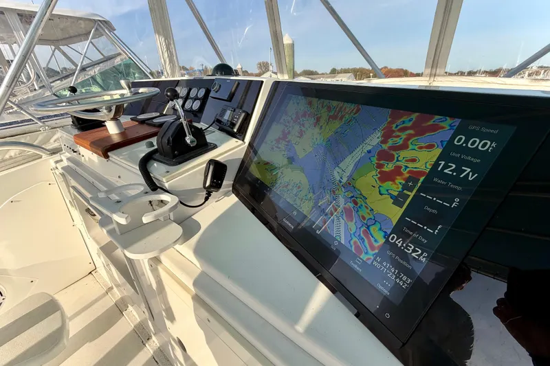 Slide: The Image of 1973 Bertram 46.6 yacht helm with modern navigation display and controls. - 30