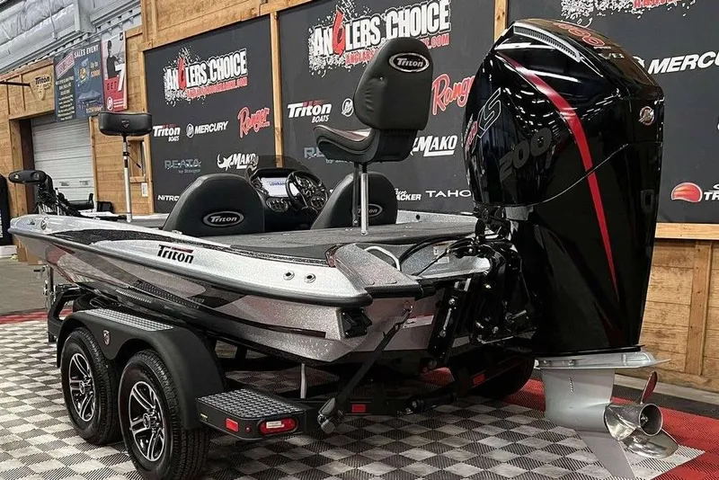 Slide: The Image of 2026 Triton 18 TrX boat with powerful engine on display at Angler's Choice event. - 5