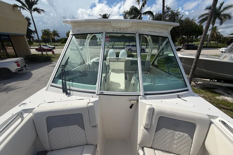 Slide: The Image of 2026 Sailfish 276 DC boat with sleek design, spacious seating, and clear windshield. - 10